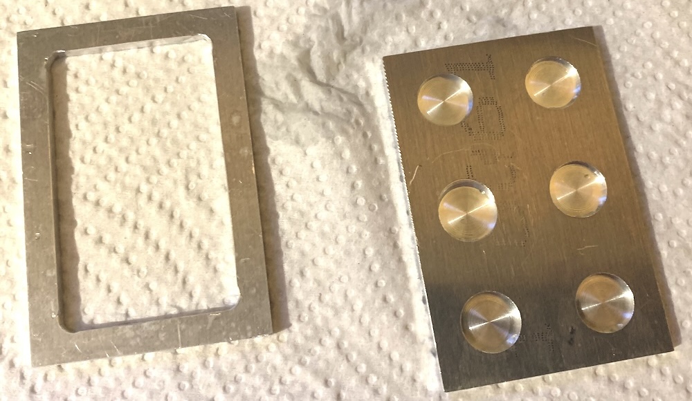 A 2x3x0.125 sample riser plate, and a 2x3x0.125 Loose Graine Holder plate, for use in a RELIOTRON